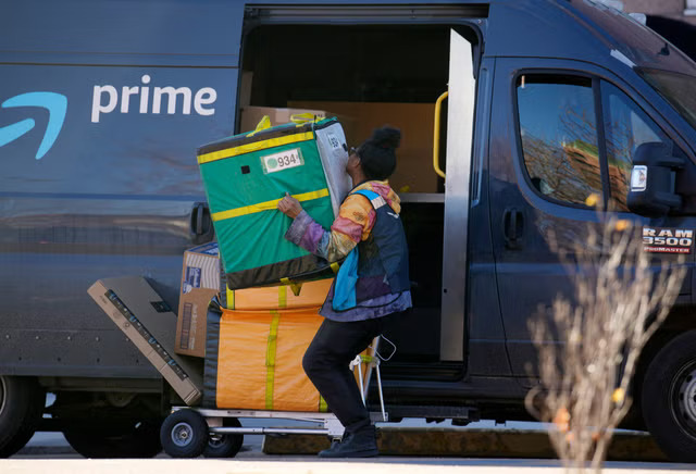 Amazon driver struggles with deliveries. (Copyright 2023 The Associated Press. All rights reserved.)